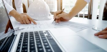 Image of engineer meeting for architectural project. working with partner and engineering tools on workplace vintage tone.